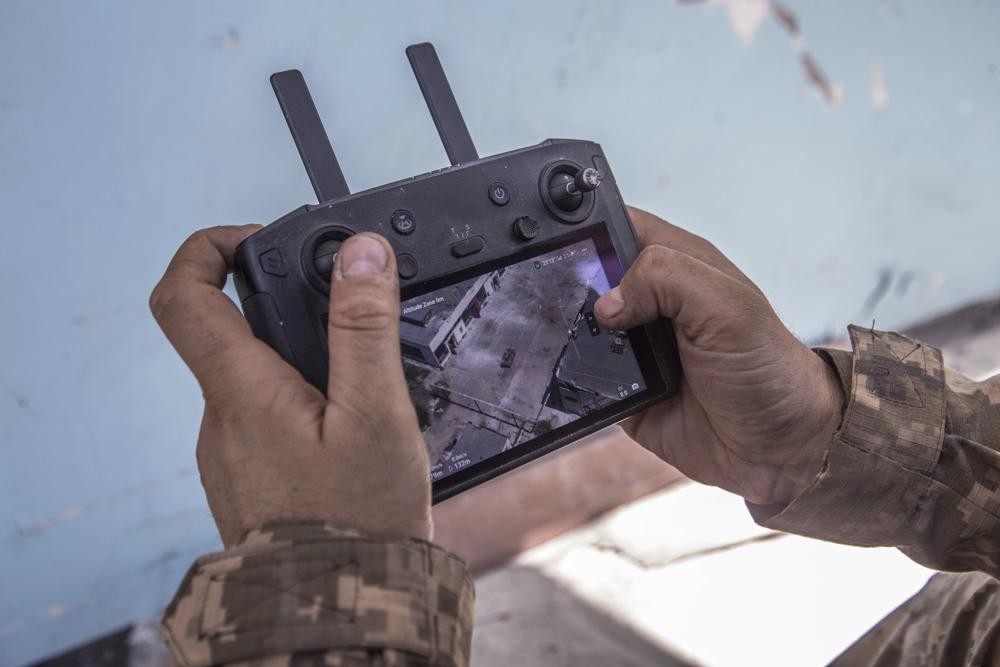 A Ukrainian soldier looks at a drone screen showing Russian troops positions during heavy fighting at the front line in Severodonetsk, Luhansk region, Ukraine, Wednesday, June 8, 2022. (AP Photo/Oleksandr Ratushniak)